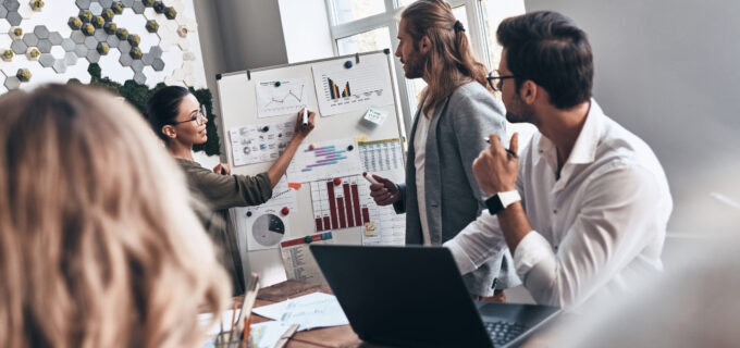 Team of innovators. Modern young man and woman conducting a business presentation while working in the office