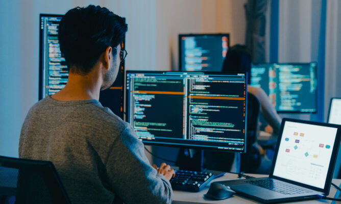 Group Adult Asia male, female freelance typing write prompt AI bot IT app smart program nomad, video game, terminal with coding language, designer, big data center on desktop computer in night office.